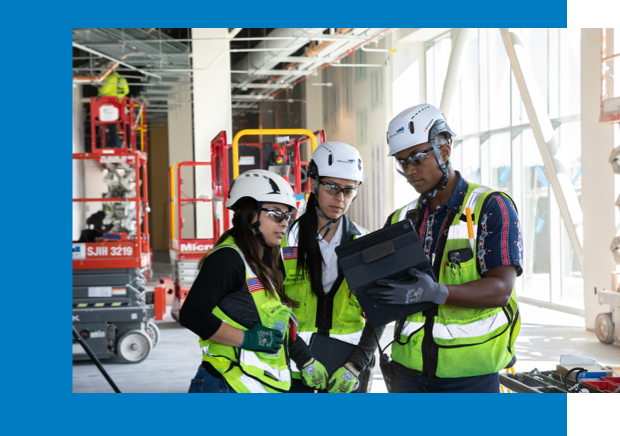 construction workers looking at tablet